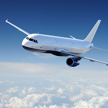 a white and blue airplane is flying in the sky