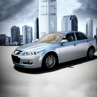 a silver car is parked in front of a city skyline