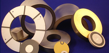 a bunch of metal disc ring plates cylinders on a blue surface