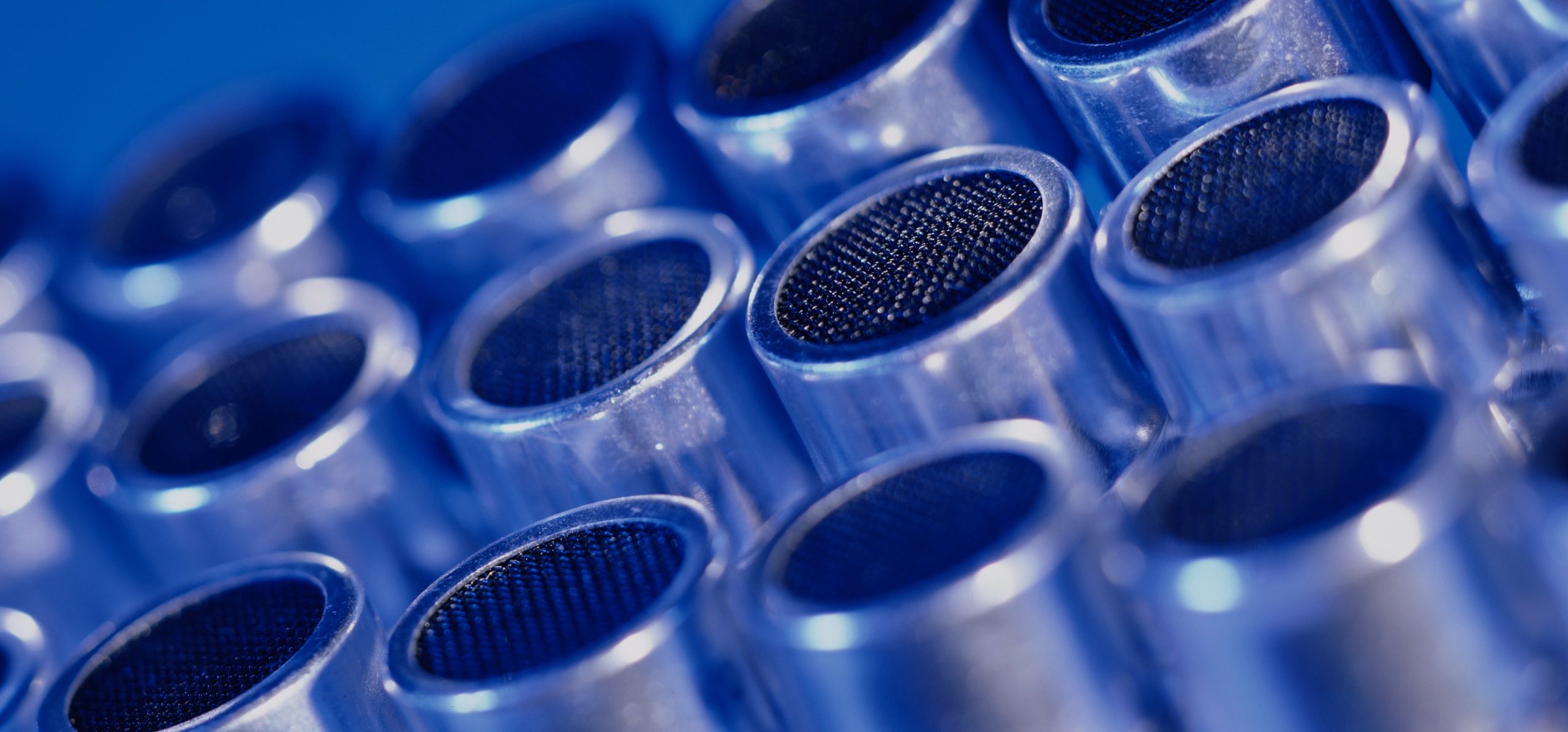 a close up of a bunch of metal pipes on a blue background