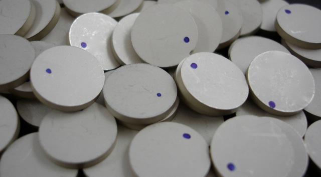 a pile of white circles with blue dots on them