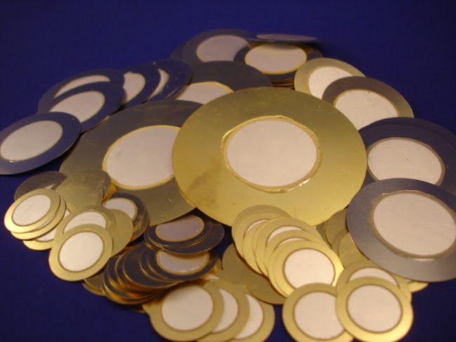 a pile of gold and silver circles on a blue surface